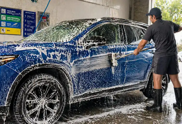 Foam soap application on car at self serve bay