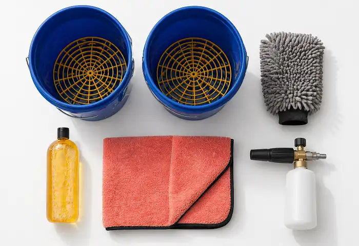 Car wash tools flat lay microfiber mitt two buckets shampoo