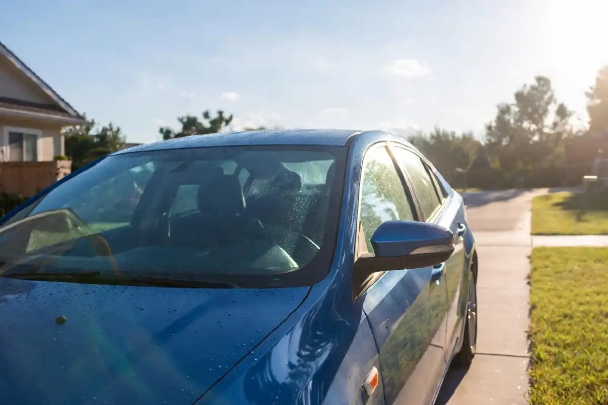 Glossy blue sedan after a bliss car wash