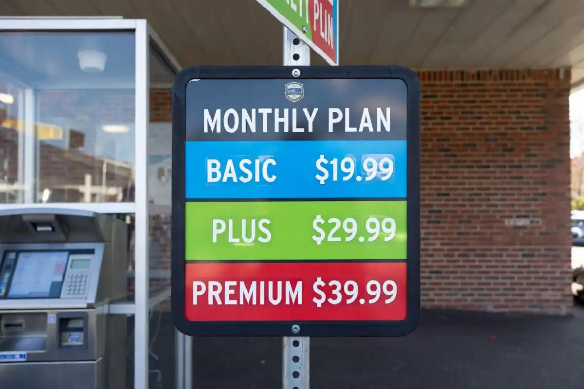 Brown Bear Car Wash Unlimited Club membership pricing board displaying monthly plan tiers at the pay station