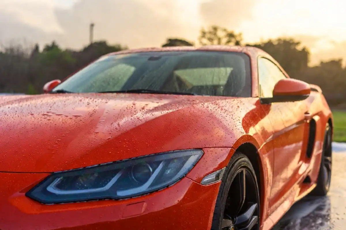 Freshly washed shiny red car with reflections