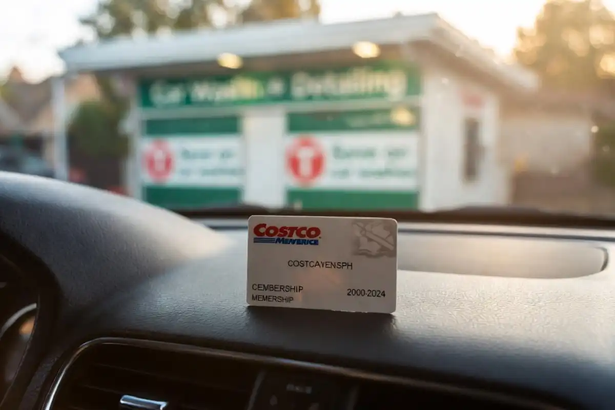 Costco membership card near a car wash pay station showing savings