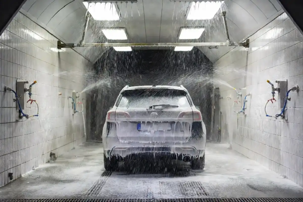 Vehicle moving through an automatic tunnel car wash at a Costco location
