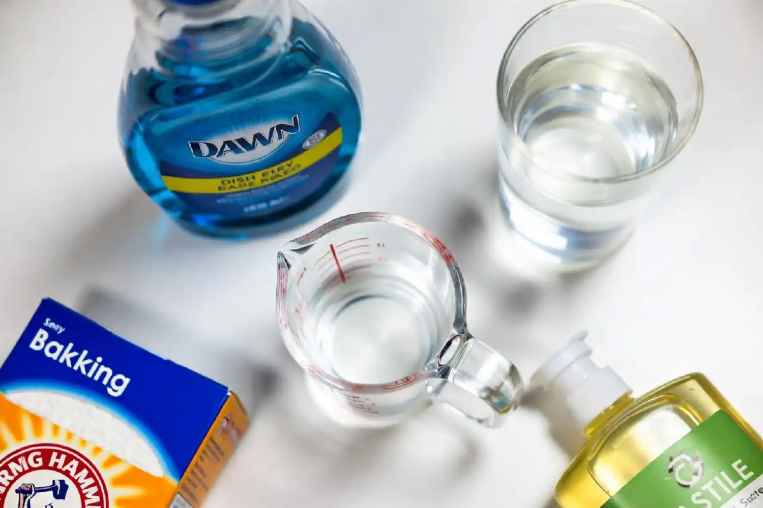 Ingredients to home make car wash soap at home — dish soap, vinegar, baking soda, castile soap