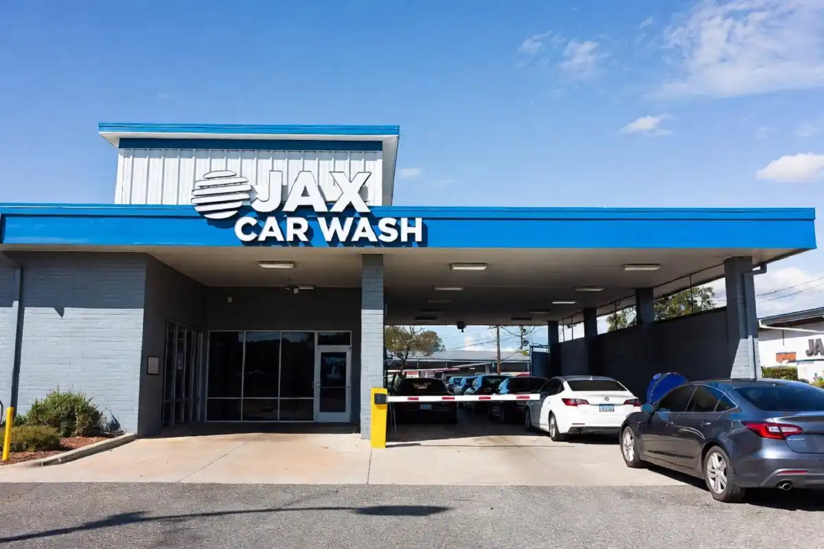 Jax Car Wash exterior location with vehicles lined up at the entrance on a clear day
