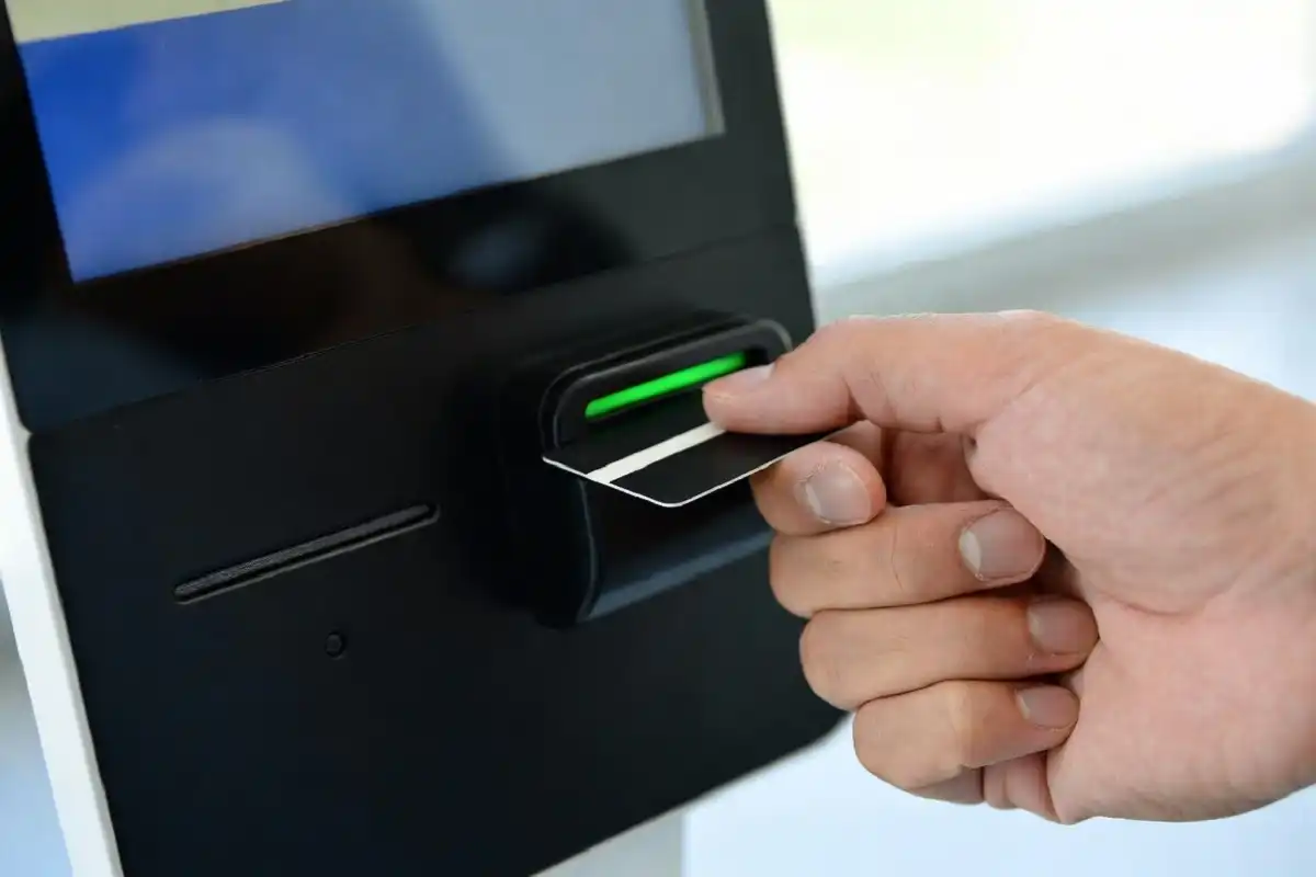 Driver scanning a Mr Car Wash Unlimited membership tag at a pay station